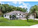 Well-maintained single-story home with lush green lawn and mature trees offering great curb appeal at 2888 Middleton Cir, Kissimmee, FL 34743
