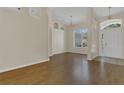 Bright foyer featuring high ceilings, decorative niches, and wood flooring at 3014 Linmont Ln, Eustis, FL 32726