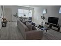 Bright living room with modern decor and wood-look flooring at 3128 Camino Real N Dr, Kissimmee, FL 34744