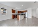 Modern kitchen with stainless steel appliances, wood cabinetry, a center island and recessed lighting at 3953 Baja Dr, St Cloud, FL 34772