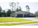Attractive home with a three-car garage, well-kept lawn, and landscaping at 5161 Kingwell Cir, Oviedo, FL 32765