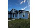 Single-story home featuring a covered entryway with columns, white-trimmed windows, and a well-maintained lawn at 567 Viceroy Ct, Kissimmee, FL 34758