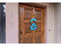 A close-up of a beautifully carved wooden front door with decorative details and a welcoming sign at 658 Lake Villas Dr, Altamonte Springs, FL 32701