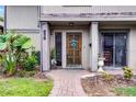 Inviting townhome front entrance with a brick path and a beautifully carved wooden door at 658 Lake Villas Dr, Altamonte Springs, FL 32701