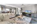 Bright living room with stylish tile floors, large rug, and open access to the dining room at 658 Lake Villas Dr, Altamonte Springs, FL 32701