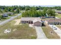 Aerial view of a single-story home with a spacious yard, driveway, and neighborhood surroundings at 7135 Sw 129Th St, Ocala, FL 34473