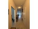 Bright hallway features tiled flooring, neutral walls, and leads to the living area at 7629 Ripplepointe Way, Windermere, FL 34786