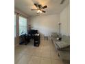 Versatile home office space with neutral walls, tiled floors, and natural light at 7629 Ripplepointe Way, Windermere, FL 34786