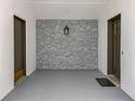 Enclosed carport with white walls and a decorative stone accent wall at 7679 Bent Bow Trl, Winter Park, FL 32792
