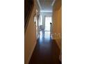 Inviting hallway with gleaming hardwood floors leading to sunlit rooms at 7842 Holiday Isle Dr # 102, Belle Isle, FL 32812