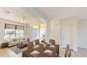 Open concept dining room and living room with lots of light, neutral paint and tile flooring at 8520 La Isla Dr, Kissimmee, FL 34747