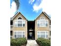 Building exterior with well-maintained landscaping showing the walkway to the units at 1057 S Hiawassee Rd # 1913, Orlando, FL 32835