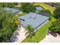 Aerial view of the single-story home with screened in lanai, well-manicured lawn, and beautiful landscaping at 13108 Lakeshore Grove Dr, Winter Garden, FL 34787