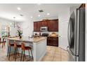 Modern kitchen with stainless steel appliances, granite countertops, and an island with seating at 15058 Sawgrass Bluff Dr, Winter Garden, FL 34787