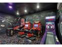 Amusement room featuring arcade games, custom murals, and unique lighting and carpet at 1533 Flange Dr, Davenport, FL 33896