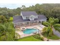 Aerial view of the home featuring a backyard pool with covered veranda at 1550 Bluewater Run, Chuluota, FL 32766