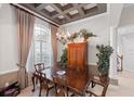 Dining room with coffered ceilings, chandelier, and large window with lots of natural light at 2046 Westover Reserve Blvd, Windermere, FL 34786