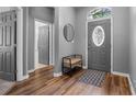 Inviting entryway featuring wood flooring, a decorative door, and a stylish bench at 210 Coleton Lane, Deland, FL 32724