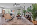 Bright living room with wood flooring, comfortable seating, and large windows at 210 Coleton Lane, Deland, FL 32724