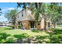 Backyard exterior featuring a well-maintained lawn and landscaping at 2193 Betsy Ross Ln, St Cloud, FL 34769
