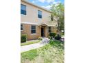 Attractive two-story townhouse showing the front entrance, landscaping, and sidewalk at 2193 Betsy Ross Ln, St Cloud, FL 34769