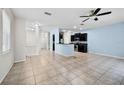 Open living room featuring tile flooring and a kitchen with stainless appliances at 2193 Betsy Ross Ln, St Cloud, FL 34769