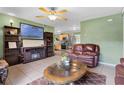 Comfortable living room with tile floors, a ceiling fan, and an open view into the kitchen at 2904 Allison Dr, Orlando, FL 32826