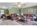 Spacious living area featuring tile floors, a ceiling fan, and ample seating for relaxation and entertainment at 2904 Allison Dr, Orlando, FL 32826