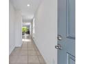 Inviting hallway with tile flooring leading into an open living area with lots of natural light at 29400 Caspian St, Leesburg, FL 34748