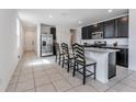 Open-concept kitchen features granite countertops, stainless steel appliances and dark cabinetry at 29400 Caspian St, Leesburg, FL 34748