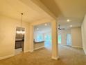 Bright living room featuring neutral paint, carpeted floor and high ceilings at 4326 Sagefield Dr, Harmony, FL 34773