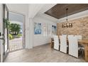 Bright dining room with wood floors, stone accent wall, and an open view to the home's entry at 5365 Bowman Dr, Winter Garden, FL 34787