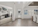 Bright foyer featuring wood floors, an elegant front door, and an open view of the dining and living areas at 5365 Bowman Dr, Winter Garden, FL 34787