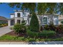 Beautiful home exterior with manicured landscaping, lush greenery and stone accents around the windows at 5365 Bowman Dr, Winter Garden, FL 34787