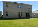 Spacious backyard with a well-manicured lawn and a cozy patio area at 6780 Coral Berry Dr, Mount Dora, FL 32757