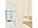 Bright entryway featuring an archway, white walls, and neutral-colored tile flooring at 6780 Coral Berry Dr, Mount Dora, FL 32757
