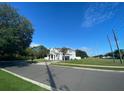 Street view of a two-story home with a landscaped yard on a clear day at 7561 Colbury Ave, Windermere, FL 34786