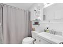 Well-lit bathroom features a tub, toilet, and storage shelves in a compact layout at 815 W Yale St, Orlando, FL 32804