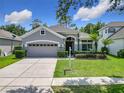 Charming home with a well-manicured lawn, a two-car garage and neatly trimmed hedges at 10875 Arbor View Blvd, Orlando, FL 32825