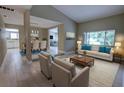 Bright living room featuring a cream sofa with blue pillows, wood floors, and ample natural light at 126 Ingram Cir, Longwood, FL 32779
