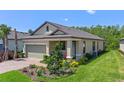 Inviting exterior view of home featuring a brick driveway, attached garage, and manicured landscaping at 1392 Lombardi Ct, Kissimmee, FL 34759