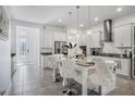 Modern kitchen with white cabinetry, granite countertops, a large island and stainless steel appliances at 14366 Alafaya Oak Bnd, Orlando, FL 32828