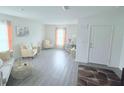 Bright living room with hardwood floors, a comfy sofa, and natural light at 1713 Redfin Way, Kissimmee, FL 34759