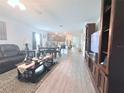 Open floor plan showcasing a dining area, kitchen, and living room with modern finishes at 1713 Redfin Way, Kissimmee, FL 34759