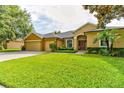 Charming single-Gathering home featuring a manicured front yard, brick driveway, and a spacious three-car garage at 1862 Lorenzo Ln, Oviedo, FL 32765