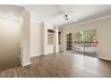 Bright living room with wood floors, neutral walls, built-in shelving, and sliding glass doors at 191 Villa Di Este Ter # 201, Lake Mary, FL 32746