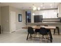 Well-lit dining room with modern furnishings adjoins kitchen, perfect for Gathering meals at 228 Primrose Dr, Davenport, FL 33837