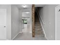 Inviting foyer with tile flooring, staircase, and neutral paint at 228 Primrose Dr, Davenport, FL 33837