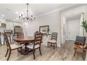 Cozy dining room with hardwood flooring, a stylish chandelier, and easy access to kitchen and entrance at 2342 Clemblue Rd, Clermont, FL 34715