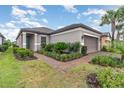 Lovely one story home with a well maintained lawn, brick walkway and beautifully landscaped front yard at 2342 Clemblue Rd, Clermont, FL 34715